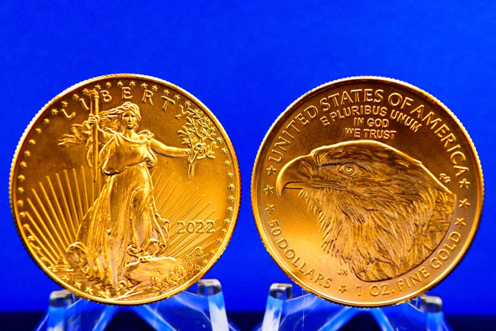 Physical American Gold Eagle held between a collector's fingers